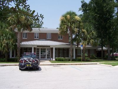 A brick building with a police car parked in front of it.
