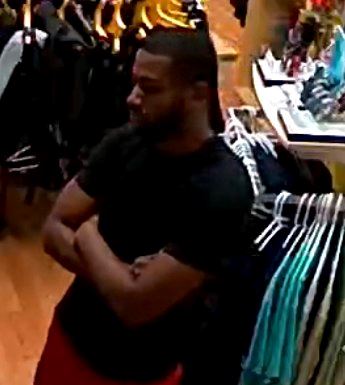 male in black shirt short hair with arms crossed