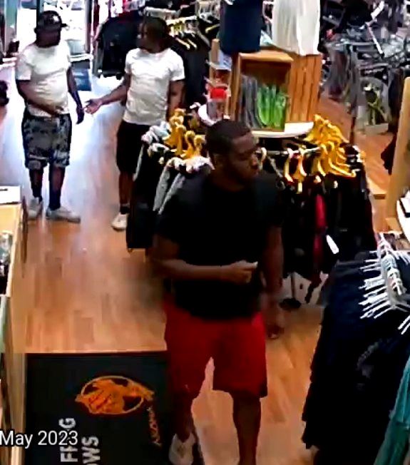 male in black shirt red shorts short hair