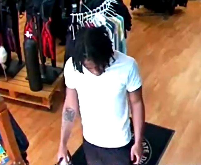 Male in white shirt dark shorts with dreads